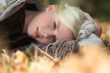Blond woman laying in leaves