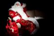 Santa sitting with a sack indoor at dark night room