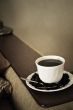 warm cup of coffee on brown background