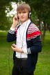 Student listening language course in headphones outside school