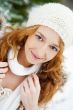 Portrait of young pretty woman in winter park