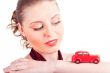 Closeup portrait of young pretty woman driving little retro car 