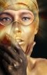 Portrait of young dancing girl with golden body art 