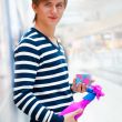 Portrait of young man inside shopping mall standing relaxed and 