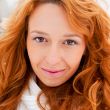 Portrait of young pretty woman in winter park 