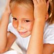 Image of smart child reading interesting book in classroom