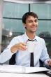 Young businessman having a morning coffee break, sitting at desk