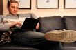 Happy young man  sitting on sofa at home
