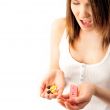 Pregnant woman holding medicine.