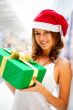 Portrait of young excited pretty woman standing inside shopping 