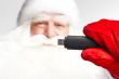 Traditional Santa Claus holding 3g usb modem in his arm on foreg