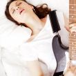 Teen girl holding a guitar like a rock star and enjoying playing
