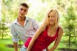 Portrait of young pretty woman and her male gay friend playing t