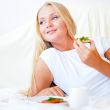 Woman having breakfast in bed. Healthy continental breakfast. Ca