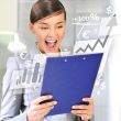Portrait if young business woman at her office holding report
