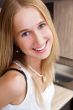 Portrait of beautiful relaxed young woman standing at the kitche