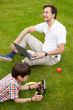 Man and young boy his son sitting outdoors 