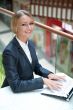 Portrait of a pretty businesswoman sitting at cafe with a laptop
