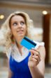 Photo of young joyful woman with shopping bags inside mall 