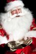 Santa sitting at the Christmas room and looking into the sack