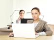 Portrait of two women working at their desks