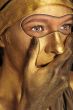 Portrait of young sexy woman in golden paint 