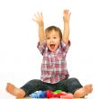 Little boy sitting and playing with balloons.
