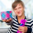 Portrait of young man inside shopping mall standing relaxed and 