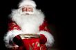 Santa sitting at the Christmas room and looking into the sack
