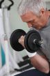 man lifting weight in sports room