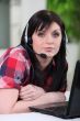 Woman laid in front of laptop with headset