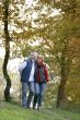 Affectionate couple strolling though park