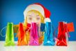 Teen girl looking from behind a row of colorful bags
