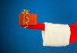 Santa`s hand holding a present