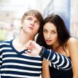 Portrait of young couple standing together at airport hall and l
