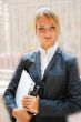 Portrait of a cute business woman with her laptop inside office 