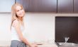 Portrait of beautiful relaxed young woman standing at the kitche