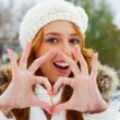 Portrait of beautiful young red hair woman outdoors in winter lo