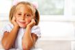 Image of smart child reading interesting book in classroom
