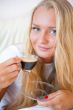 Closeup portrait of a pretty young female having a cup of coffee