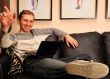 Happy young man  sitting on sofa at home