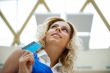 Beautiful shopping woman holding a credit card