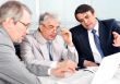 Portrait of three businessmen at the computer.