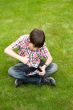 Young boy outdoors on the grass at backyard