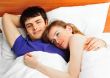 Young man and woman in bed. Couple.