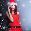Portrait of beautiful young christmas woman posing wearing santa
