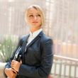 Portrait of a cute business woman with her laptop inside office 