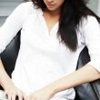 Portrait of a beautiful young woman working on laptop while sitt