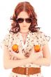 Shot of a beautiful young woman with mandarins near breast. Food