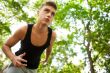 Closeup portrait of young man running in park